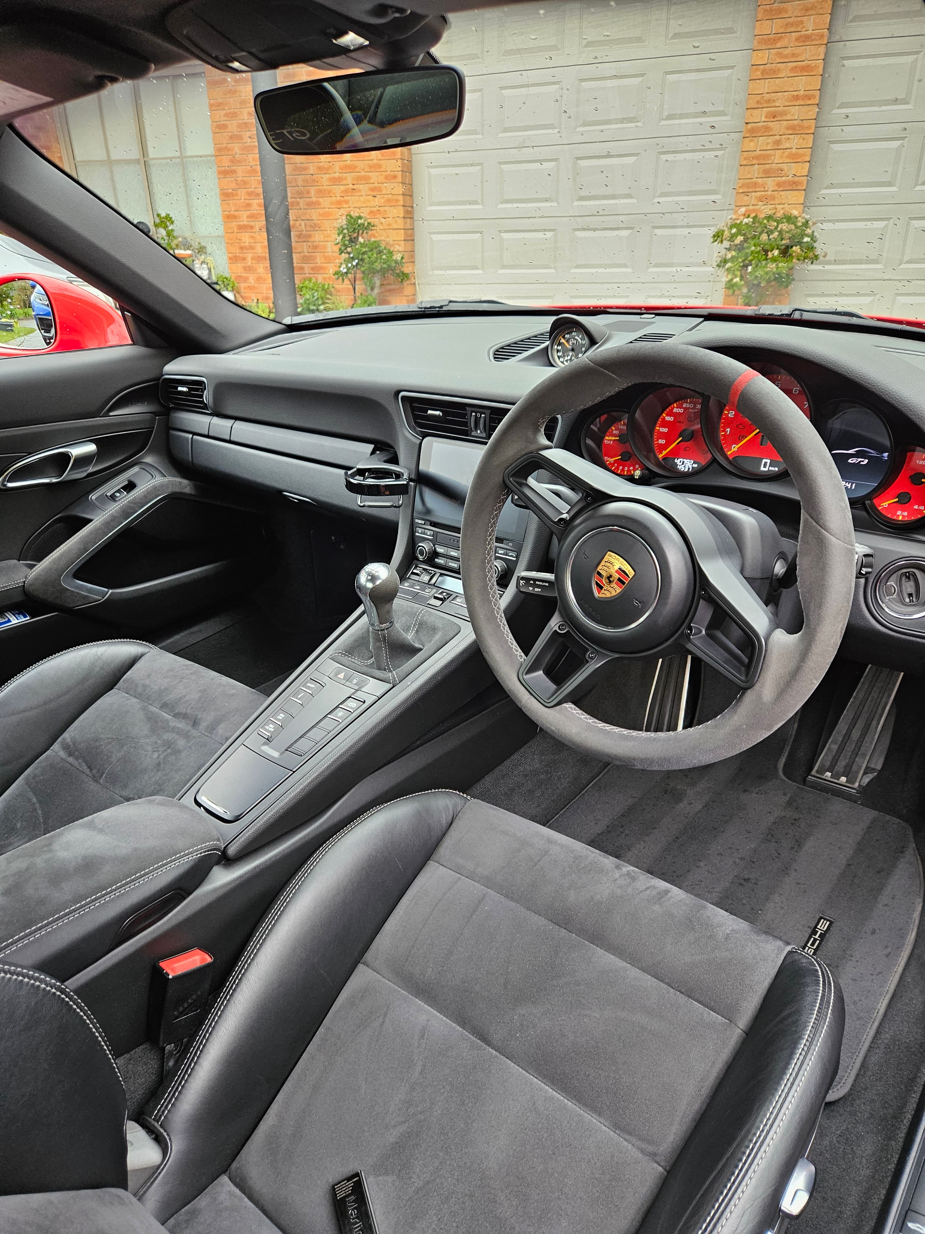 Detailer working on red sports car